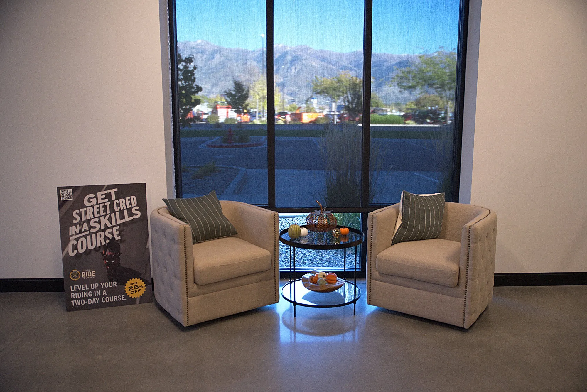 Two armchairs by a tall window with the Wasatch foothills outside