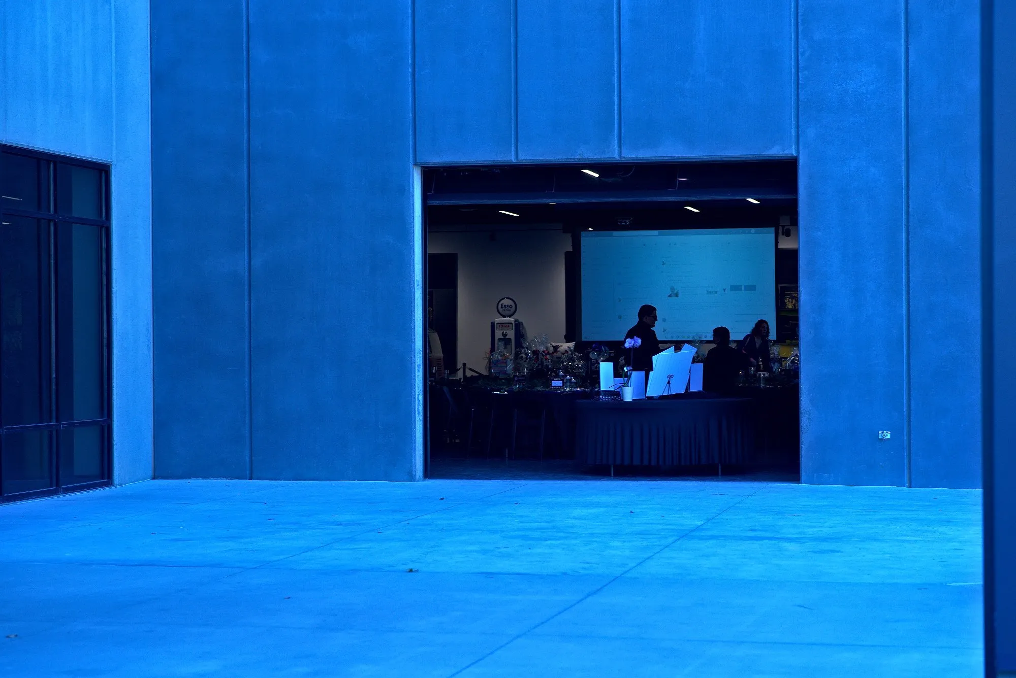 The loading door lit blue from inside, the party glowing through the opening