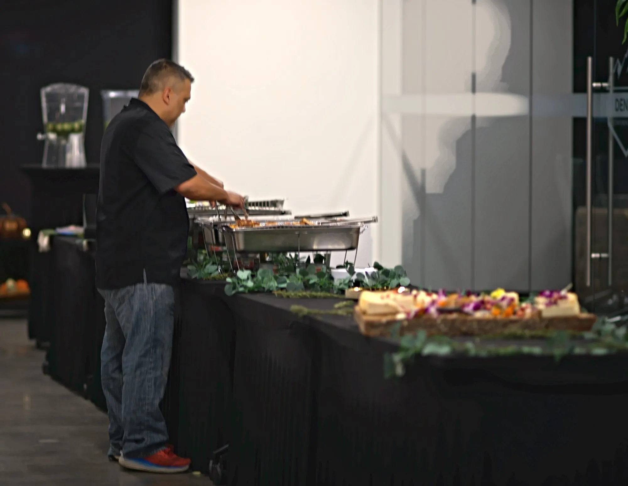 The chef working the buffet line beside the chafing dishes before guests arrive