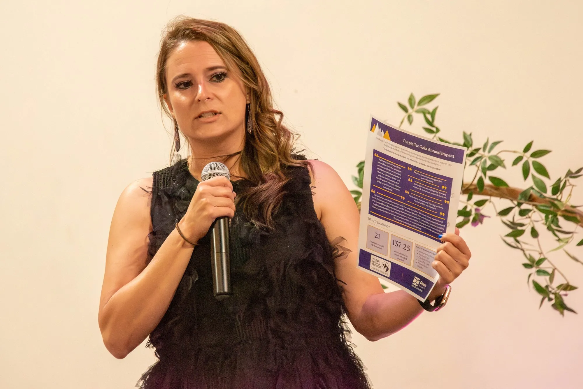 Remarks from the podium with a microphone and printed notes at the gala