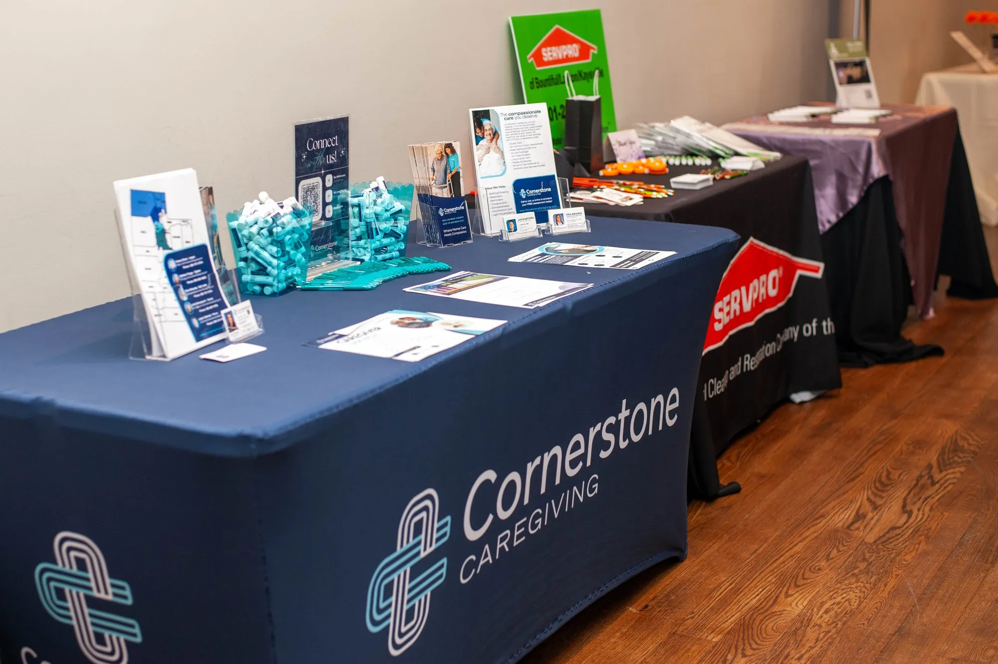 Sponsor table with branded tablecloth and giveaway items