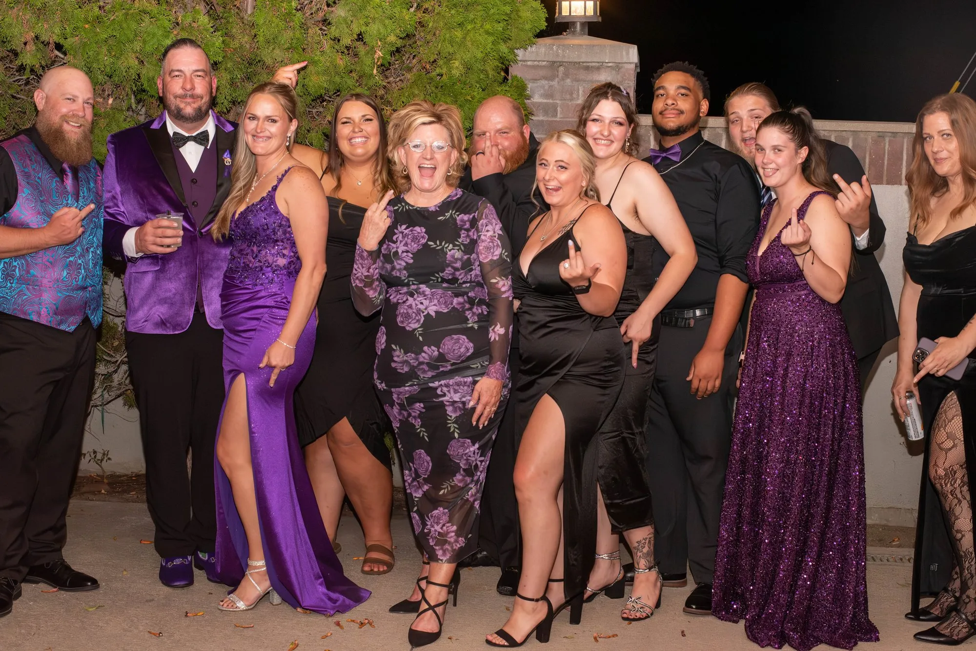 Large group of guests in purple lined up for a photo