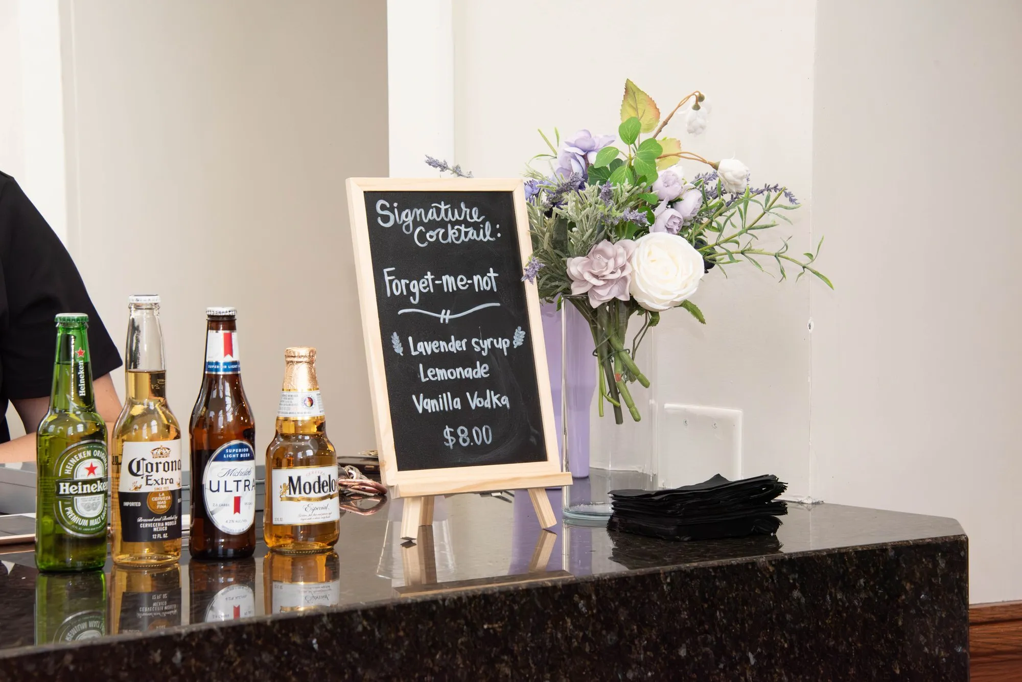 Bar area with a floral arrangement before the crowd arrives